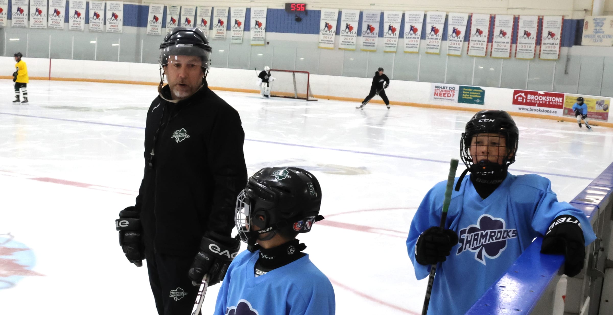 Jesse talking two players through a drill at the boards